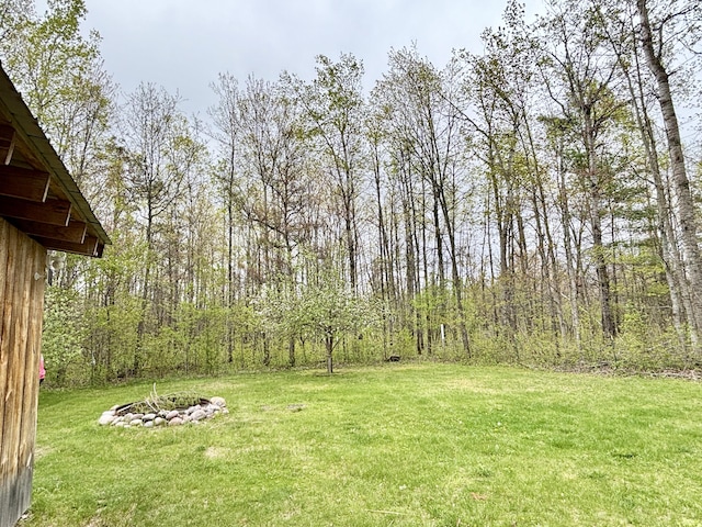 2872 Granger Rd, Lewiston, MI 49756 - view of green lawn with a fire pit and a forest view