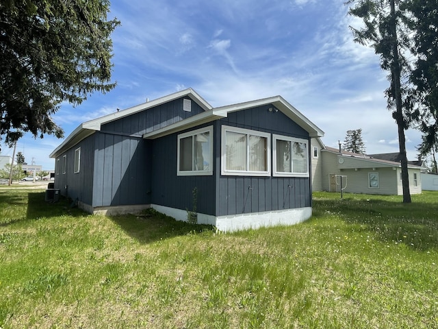120 S Indiana Ave, Gaylord, MI 49735 - view of property exterior featuring a yard and central AC unit