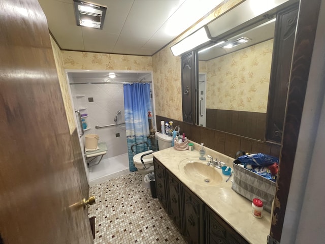 120 S Indiana Ave, Gaylord, MI 49735 - full bath with wallpapered walls, toilet, curtained shower, vanity, and wainscoting