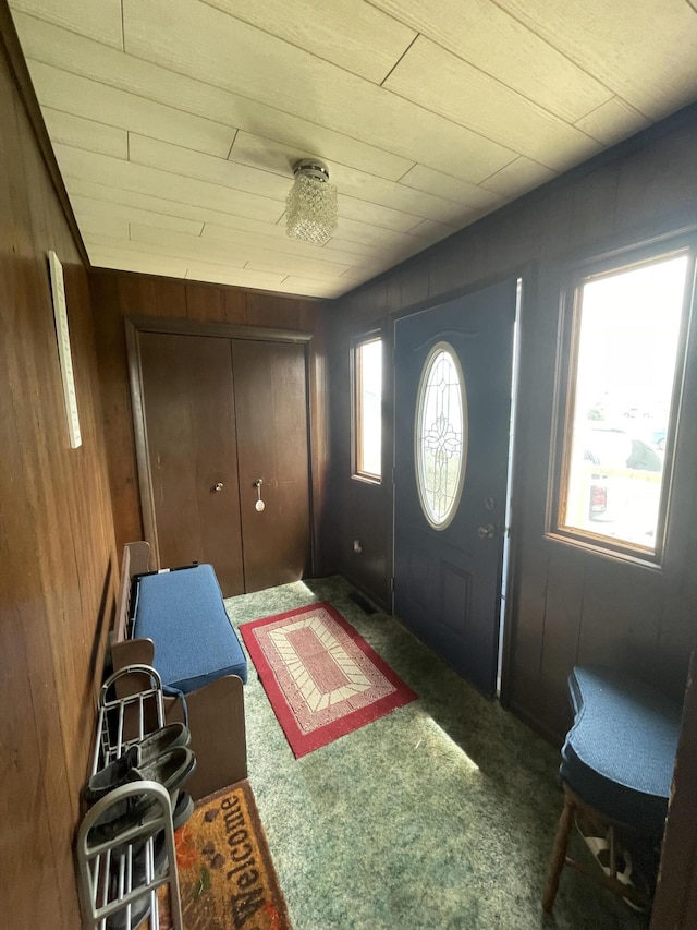 120 S Indiana Ave, Gaylord, MI 49735 - carpeted foyer entrance featuring wooden walls and wood ceiling