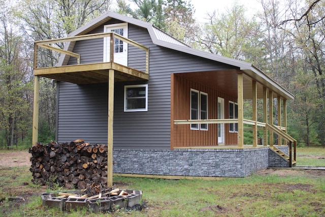 186 S Gerber Rd, Mio, MI 48647 - view of side of home featuring a balcony and stone siding