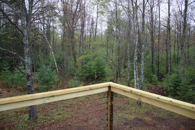 186 S Gerber Rd, Mio, MI 48647 - wooden terrace featuring a wooded view