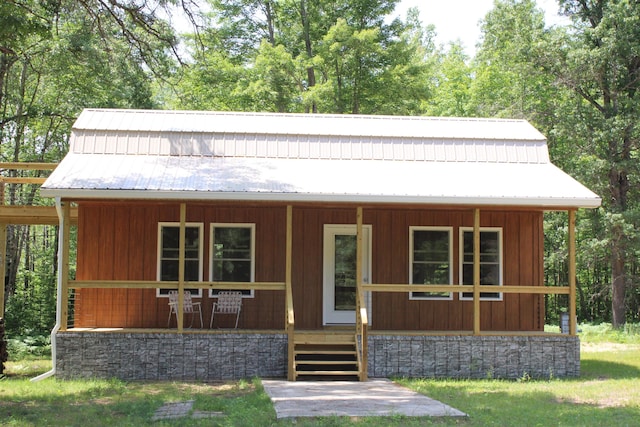 186 S Gerber Rd, Mio, MI 48647 - view of front of home featuring a porch and a metal roof