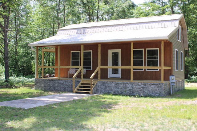 186 S Gerber Rd, Mio, MI 48647 - view of front of property with covered porch, a metal roof, and a front lawn