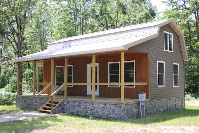 186 S Gerber Rd, Mio, MI 48647 - view of front of property featuring covered porch and a metal roof