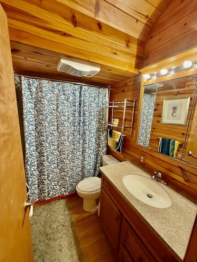 19110 Red Pine Dr, Hillman, MI 49746 - full bathroom with wood finished floors, vanity, wooden walls, toilet, and lofted ceiling
