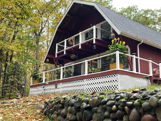 19110 Red Pine Dr, Hillman, MI 49746 - view of front of house featuring a balcony and a shingled roof