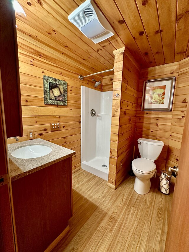 19110 Red Pine Dr, Hillman, MI 49746 - full bath featuring wood ceiling, toilet, a shower stall, wood finished floors, and wooden walls