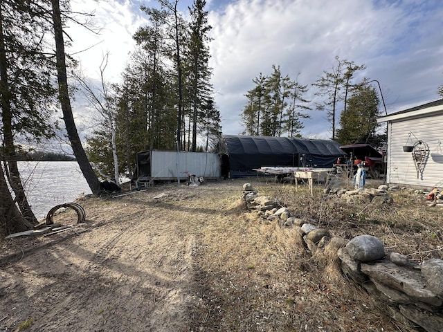 3469 Long Rapids Rd, Alpena, MI 49707 - view of yard with an outbuilding and a water view