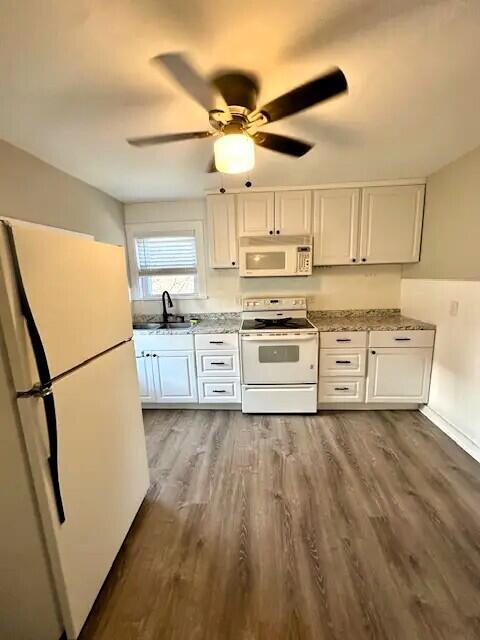 310 W Campbell St, Alpena, MI 49707 - kitchen with white appliances, a sink, white cabinetry, dark wood-style floors, and ceiling fan