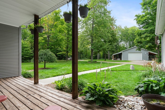11882 Davis Creek Dr, Wolverine, MI 49799 - wooden terrace featuring a garage, a lawn, an outdoor structure, and view of scattered trees