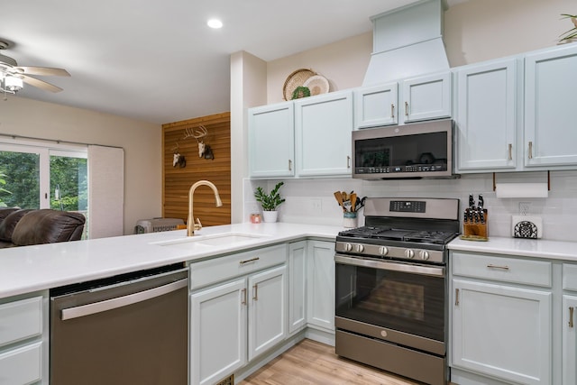 11882 Davis Creek Dr, Wolverine, MI 49799 - kitchen with stainless steel appliances, a sink, tasteful backsplash, light countertops, and ceiling fan