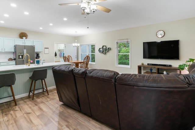 11882 Davis Creek Dr, Wolverine, MI 49799 - living room with light wood finished floors, recessed lighting, ceiling fan, and a chandelier