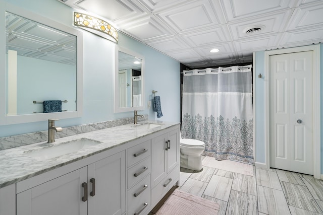 11882 Davis Creek Dr, Wolverine, MI 49799 - bathroom with toilet, recessed lighting, double vanity, an ornate ceiling, and a shower with shower curtain
