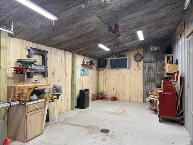 11882 Davis Creek Dr, Wolverine, MI 49799 - garage with wood walls and a workshop area