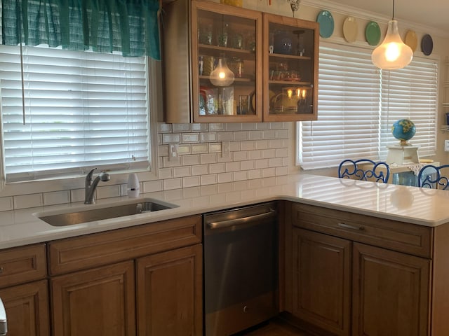 1253 N Partridge Point Rd, Alpena, MI 49707 - kitchen with dishwasher, a sink, backsplash, light countertops, and glass insert cabinets
