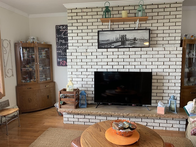 1253 N Partridge Point Rd, Alpena, MI 49707 - living area with a fireplace, crown molding, and wood finished floors