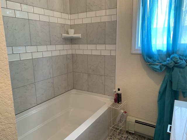 1253 N Partridge Point Rd, Alpena, MI 49707 - bathroom featuring a baseboard radiator and a bath