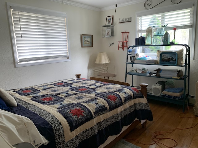 1253 N Partridge Point Rd, Alpena, MI 49707 - bedroom featuring wood finished floors and crown molding