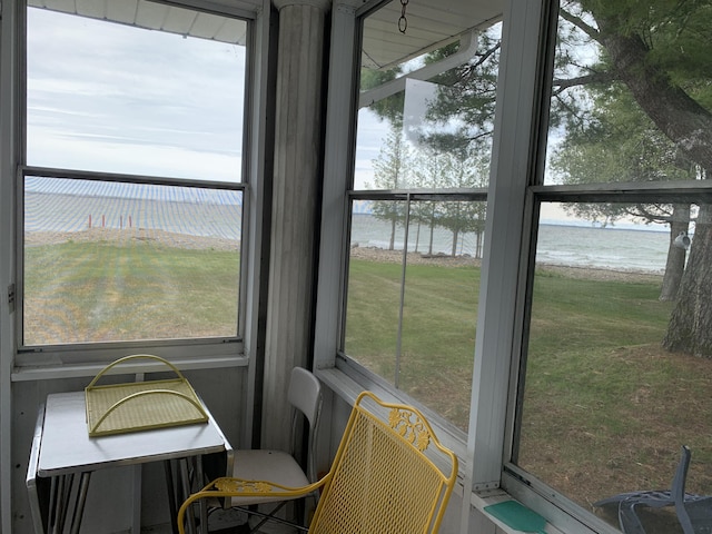 1253 N Partridge Point Rd, Alpena, MI 49707 - sunroom featuring a water view and plenty of natural light