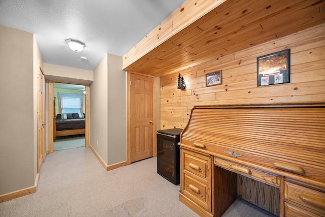 14250 Chippewa Trl, Johannesburg, MI 49751 - office with baseboards, light colored carpet, and wood walls