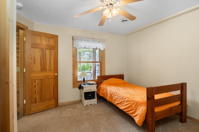 14250 Chippewa Trl, Johannesburg, MI 49751 - bedroom with light carpet, baseboards, and ceiling fan