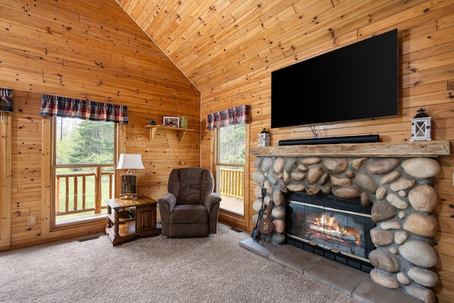 14250 Chippewa Trl, Johannesburg, MI 49751 - carpeted living room featuring wooden ceiling, wood walls, a stone fireplace, and high vaulted ceiling