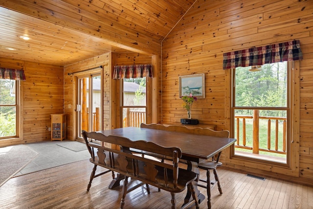 14250 Chippewa Trl, Johannesburg, MI 49751 - dining space with light wood-style flooring, wood ceiling, wood walls, and lofted ceiling