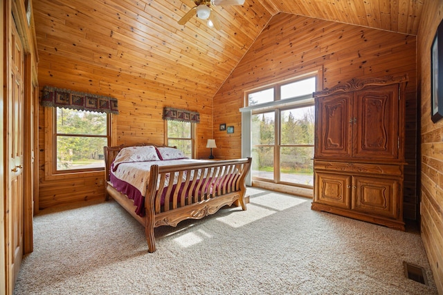 14250 Chippewa Trl, Johannesburg, MI 49751 - bedroom with wooden walls, carpet, high vaulted ceiling, wood ceiling, and access to exterior