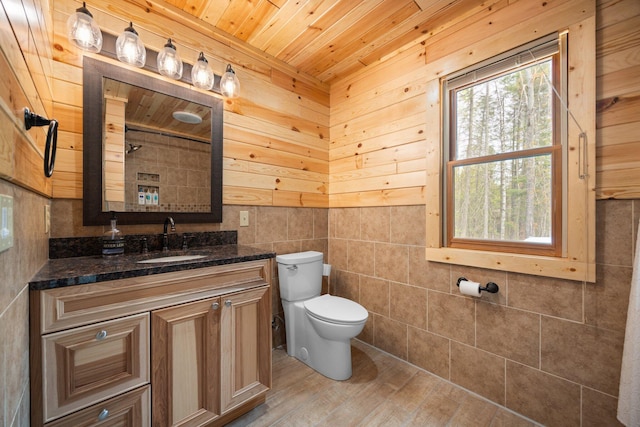 14250 Chippewa Trl, Johannesburg, MI 49751 - bathroom featuring wood ceiling, toilet, vanity, wood finished floors, and wooden walls