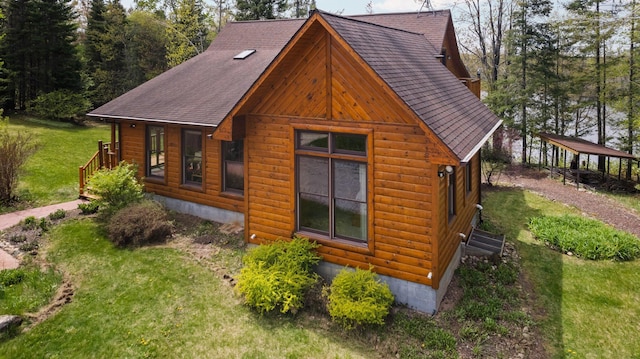 14250 Chippewa Trl, Johannesburg, MI 49751 - view of side of property with a yard and a shingled roof