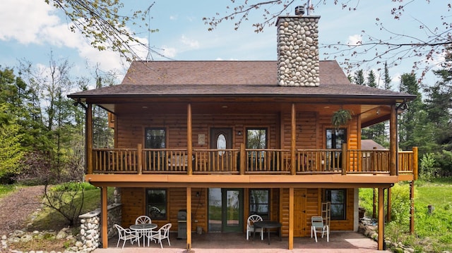 14250 Chippewa Trl, Johannesburg, MI 49751 - rear view of property with a patio, faux log siding, a shingled roof, a deck, and a chimney