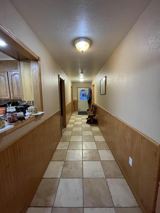 445 Noric Dr, Roscommon, MI 48653 - corridor with wainscoting, wood walls, and a textured ceiling