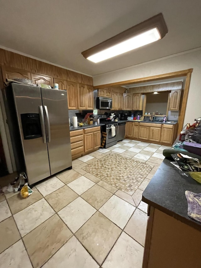 445 Noric Dr, Roscommon, MI 48653 - kitchen featuring appliances with stainless steel finishes, dark countertops, crown molding, brown cabinets, and a sink
