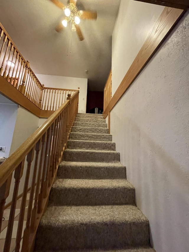 445 Noric Dr, Roscommon, MI 48653 - stairs featuring a ceiling fan and a textured wall