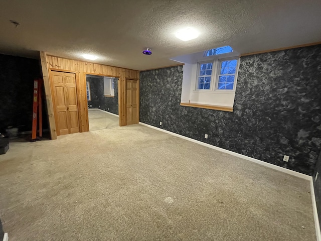 445 Noric Dr, Roscommon, MI 48653 - finished basement with carpet flooring, a textured ceiling, wallpapered walls, and baseboards