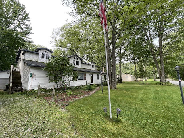 445 Noric Dr, Roscommon, MI 48653 - view of grassy yard with stairs and view of scattered trees