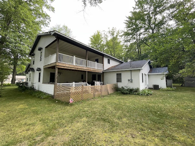 445 Noric Dr, Roscommon, MI 48653 - rear view of house featuring a balcony, a yard, central AC unit, and roof with shingles