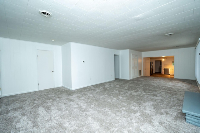 206 Harvey Ave, Houghton Lake, MI 48629 - unfurnished living room featuring carpet floors and baseboards
