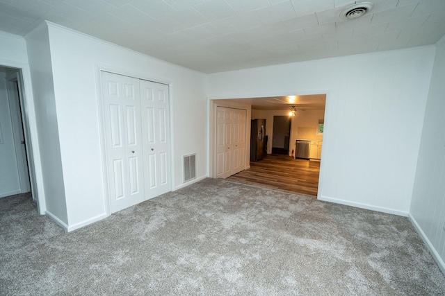 206 Harvey Ave, Houghton Lake, MI 48629 - unfurnished bedroom featuring carpet flooring, crown molding, baseboards, and a closet