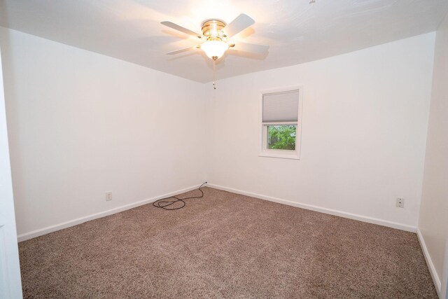 206 Harvey Ave, Houghton Lake, MI 48629 - spare room featuring carpet flooring, baseboards, and a ceiling fan