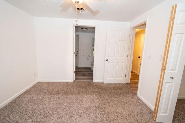 206 Harvey Ave, Houghton Lake, MI 48629 - unfurnished bedroom with carpet flooring, baseboards, ensuite bath, and a ceiling fan