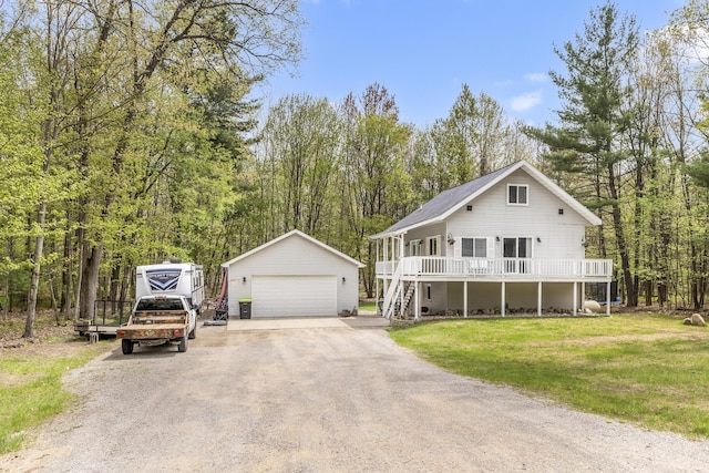 120 Seminole Trl, Roscommon, MI 48653 - view of front of home with a garage, an outdoor structure, stairs, a front yard, and a wooden deck