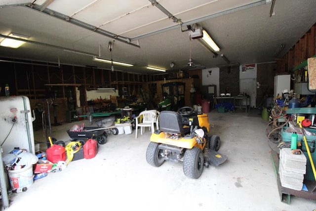 5432 E Michigan Hwy, Roscommon, MI 48653 - garage with a workshop area and a garage door opener