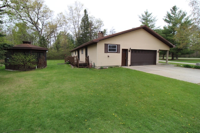 5432 E Michigan Hwy, Roscommon, MI 48653 - view of home's exterior with a chimney, a yard, a gazebo, and concrete driveway