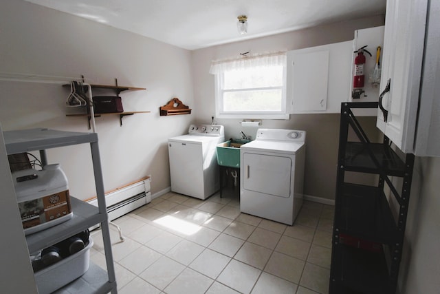 5432 E Michigan Hwy, Roscommon, MI 48653 - washroom featuring washing machine and clothes dryer, a baseboard heating unit, and light tile patterned floors