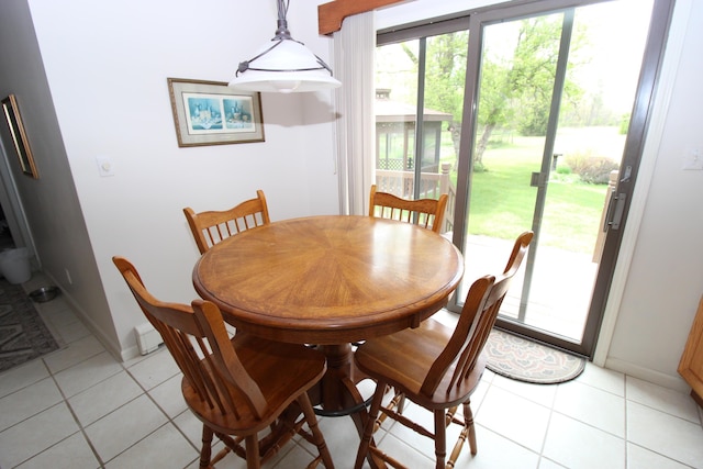 5432 E Michigan Hwy, Roscommon, MI 48653 - dining space featuring light tile patterned flooring and baseboards