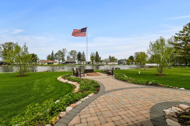 6801 Driftwood Cv, Saint Helen, MI 48656 - view of property's community with a lawn, a water view, a patio, and an outdoor fire pit