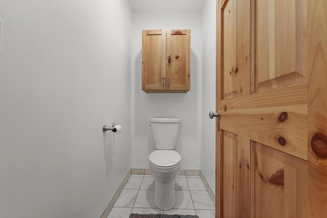 6801 Driftwood Cv, Saint Helen, MI 48656 - half bath featuring toilet, baseboards, and marble look tile flooring
