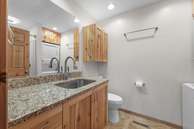 6801 Driftwood Cv, Saint Helen, MI 48656 - bathroom with toilet, vanity, washer / clothes dryer, baseboards, and a shower